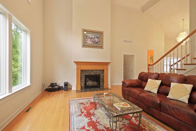 living room featuring hardwood / wood-style floors, a wealth of natural light, a fireplace, and high vaulted ceiling