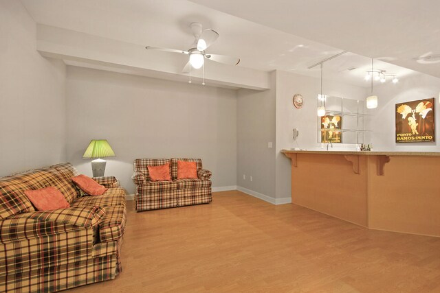 living room featuring ceiling fan and light hardwood / wood-style flooring