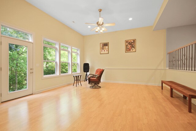 living area with light wood-type flooring and ceiling fan