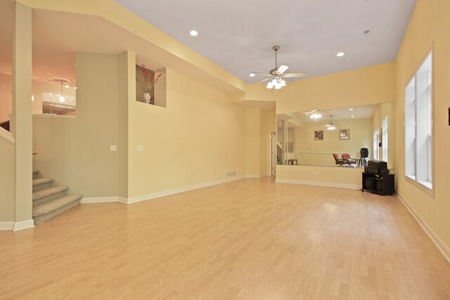 unfurnished living room featuring hardwood / wood-style flooring and ceiling fan