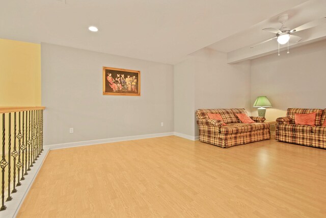 unfurnished living room featuring ceiling fan and light wood-type flooring