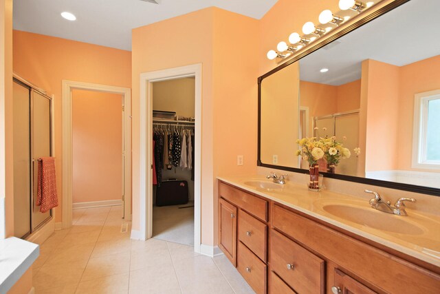 bathroom featuring vanity, tile patterned floors, and a shower with door