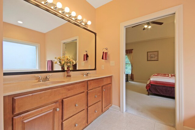 bathroom with tile patterned flooring, vanity, and ceiling fan