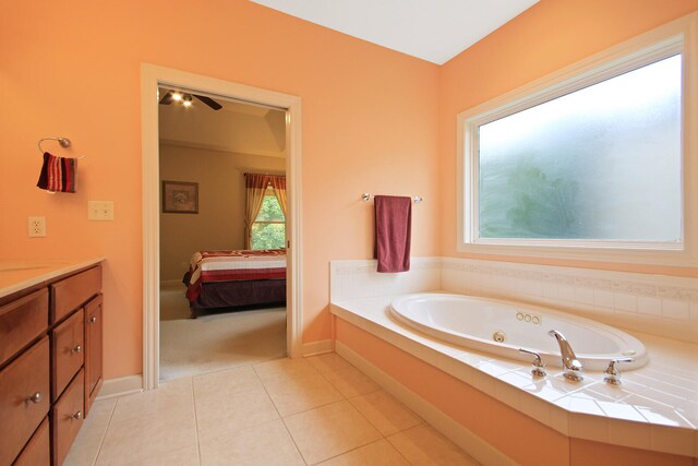 bathroom with a tub to relax in, vanity, and tile patterned flooring