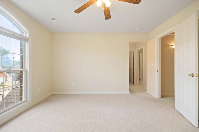 unfurnished room with light carpet and ceiling fan