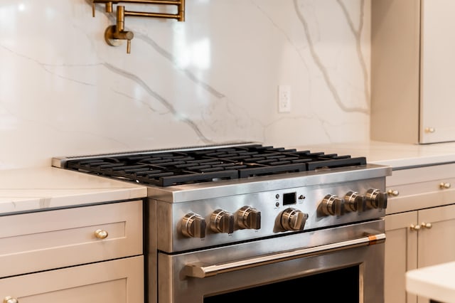 kitchen with decorative backsplash and high end stainless steel range oven