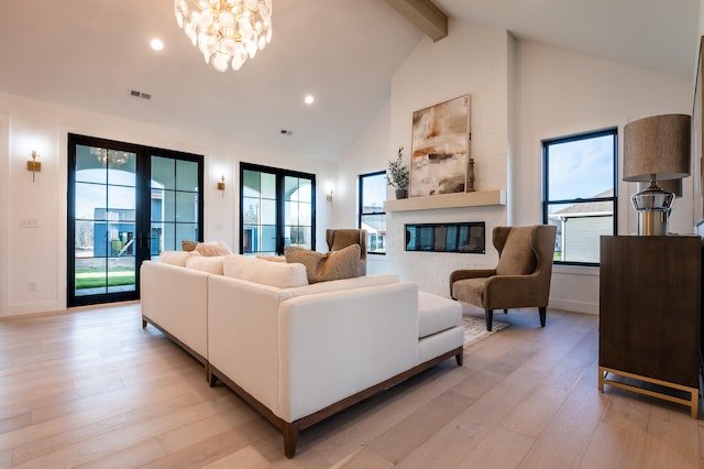 living room featuring high vaulted ceiling, beamed ceiling, light wood-type flooring, french doors, and a chandelier