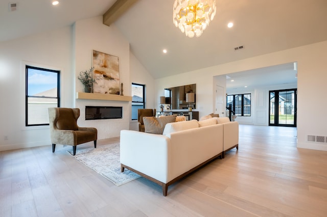 living room featuring beamed ceiling, light wood-type flooring, high vaulted ceiling, and a wealth of natural light