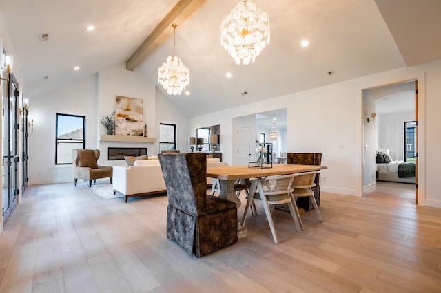 dining room with high vaulted ceiling, a chandelier, light hardwood / wood-style floors, and beamed ceiling