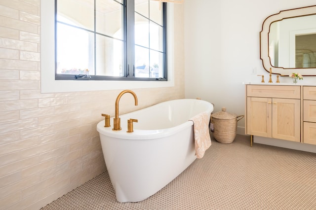 bathroom featuring vanity, tile walls, and a washtub