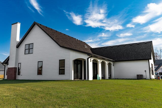 back of house with a lawn