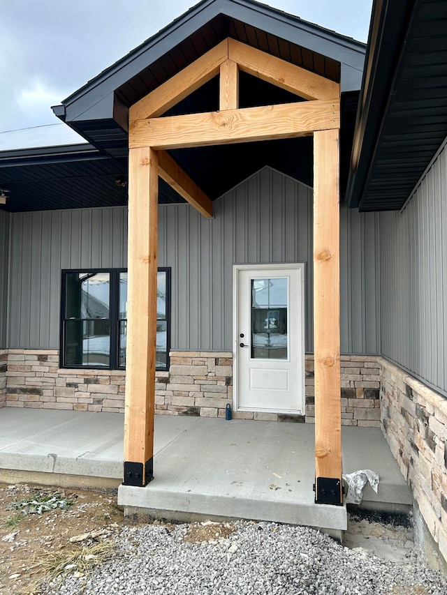 view of exterior entry with a porch