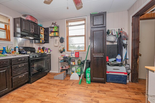 kitchen featuring ceiling fan, dark brown cabinets, light wood-type flooring, and black gas stove