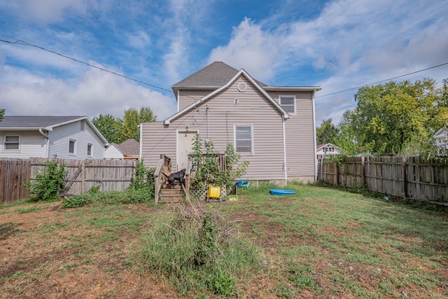 rear view of property with a lawn