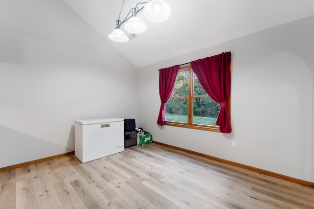 interior space featuring lofted ceiling and light hardwood / wood-style floors