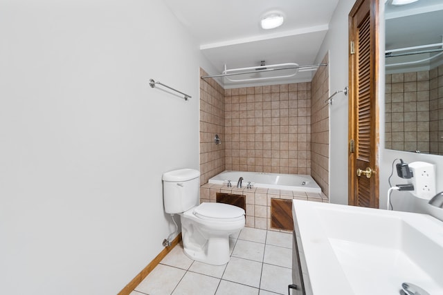 full bathroom with tiled shower / bath, vanity, toilet, and tile patterned floors