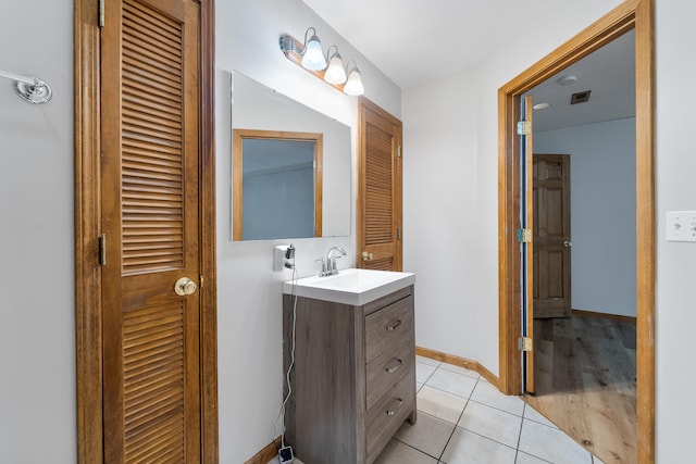 bathroom featuring tile patterned flooring and vanity