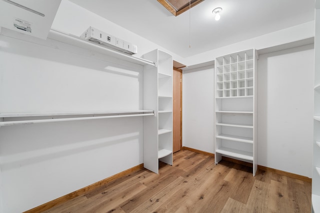 walk in closet featuring light hardwood / wood-style floors