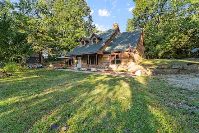 rear view of property with a yard