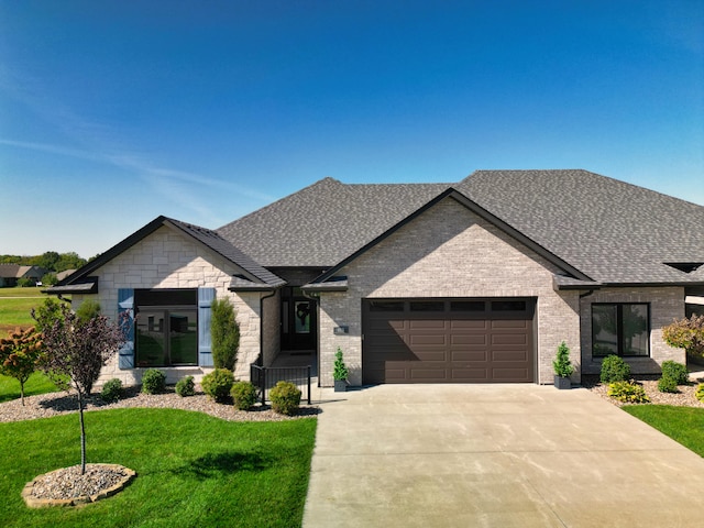 view of front facade with a garage and a front lawn