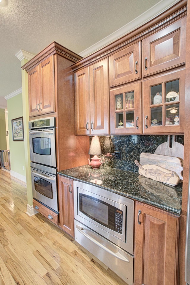 4200 S Rangeline Rd, Columbia, MO 65201 - kitchen with crown molding, appliances with stainless steel finishes, light wood finished floors, tasteful backsplash, and a warming drawer