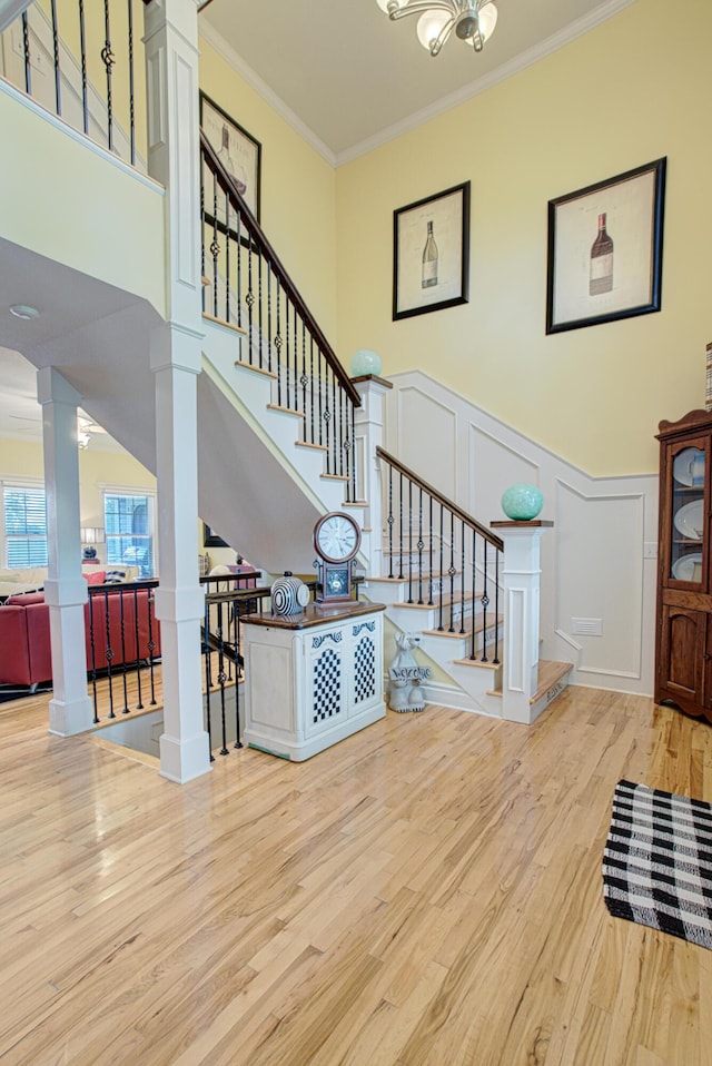 4200 S Rangeline Rd, Columbia, MO 65201 - staircase with a decorative wall, crown molding, wood finished floors, ornate columns, and a wainscoted wall