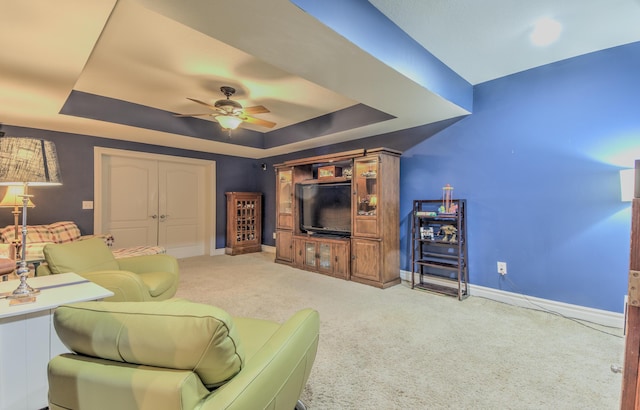 4200 S Rangeline Rd, Columbia, MO 65201 - living room with a tray ceiling, a ceiling fan, baseboards, and carpet