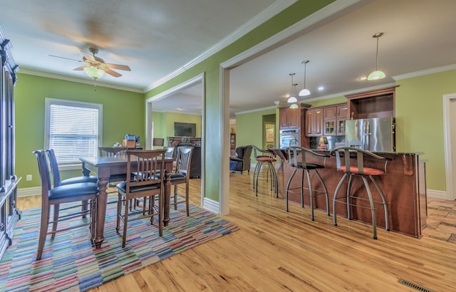 4200 S Rangeline Rd, Columbia, MO 65201 - dining space with a ceiling fan, light wood-style floors, baseboards, and ornamental molding