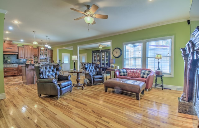 4200 S Rangeline Rd, Columbia, MO 65201 - living area featuring a ceiling fan, light wood-type flooring, crown molding, a fireplace with flush hearth, and baseboards
