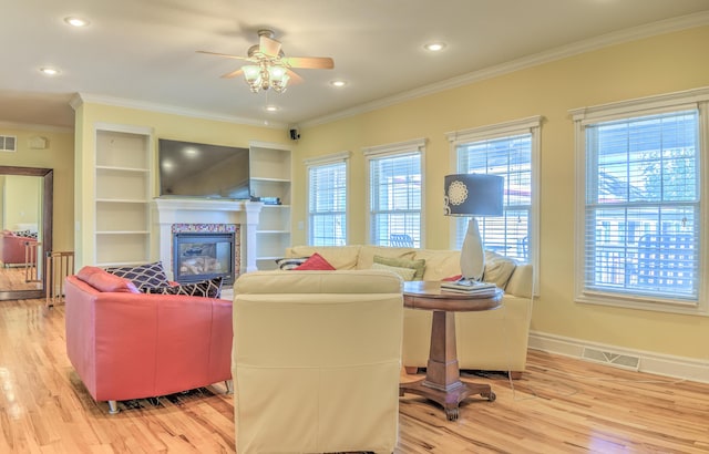 4200 S Rangeline Rd, Columbia, MO 65201 - living room with light wood-type flooring, a ceiling fan, a tile fireplace, ornamental molding, and recessed lighting
