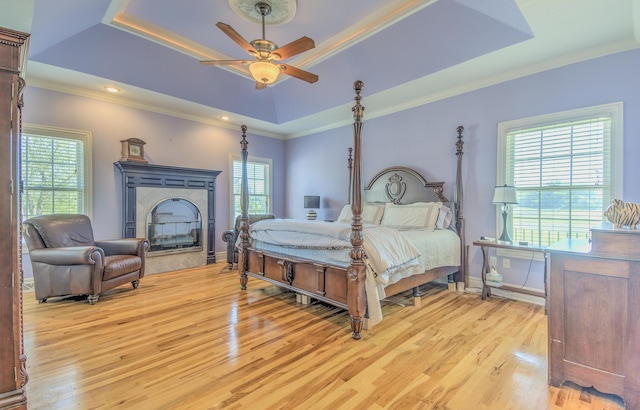4200 S Rangeline Rd, Columbia, MO 65201 - bedroom featuring a tray ceiling, multiple windows, light wood finished floors, crown molding, and baseboards