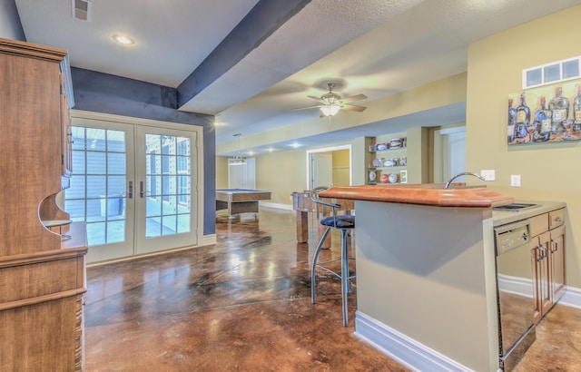 4200 S Rangeline Rd, Columbia, MO 65201 - kitchen with french doors, a breakfast bar area, baseboards, dishwashing machine, and recessed lighting