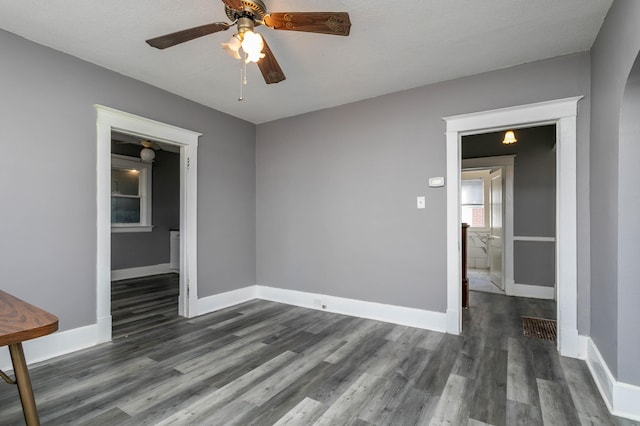 unfurnished room featuring a textured ceiling, dark hardwood / wood-style floors, and ceiling fan