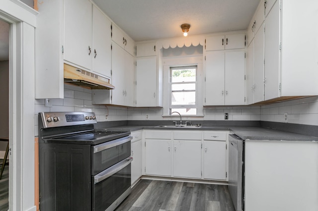 kitchen featuring stainless steel appliances, sink, and white cabinetry