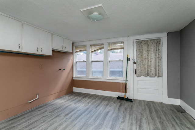 interior space featuring a textured ceiling and light hardwood / wood-style floors