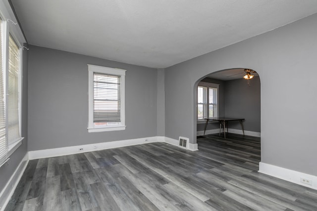 spare room featuring ceiling fan, hardwood / wood-style flooring, and a textured ceiling