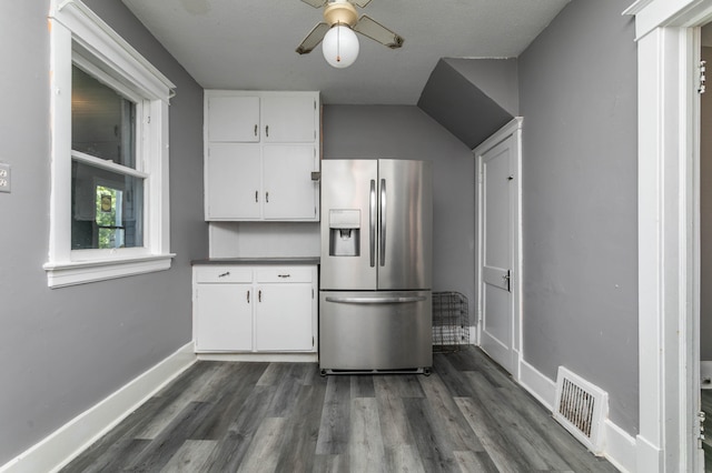 kitchen with stainless steel fridge, white cabinetry, dark hardwood / wood-style flooring, and ceiling fan