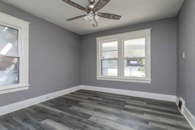 empty room featuring ceiling fan and dark hardwood / wood-style flooring