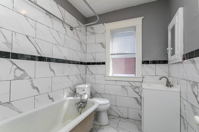 full bathroom featuring vanity, tile walls, toilet, and shower / washtub combination