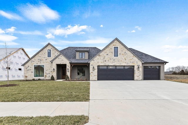 view of front of home with a garage and a front yard