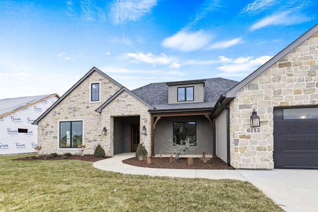 view of front of home featuring a garage and a front lawn