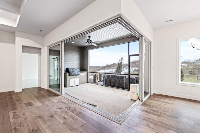 interior space featuring wood-type flooring and ceiling fan