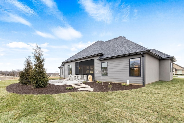 back of house featuring a lawn and a patio