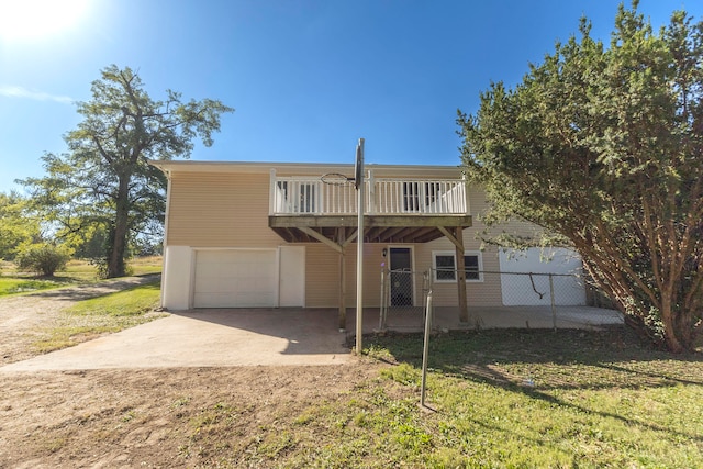 front facade with a garage and a front lawn