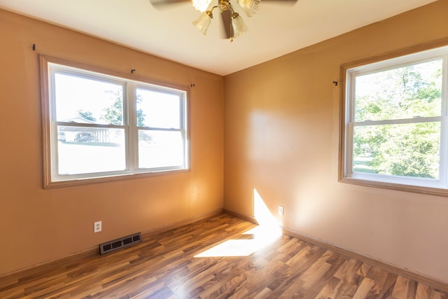 unfurnished room featuring ceiling fan and dark hardwood / wood-style flooring