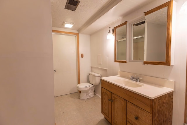 bathroom featuring an enclosed shower, vanity, toilet, and a textured ceiling