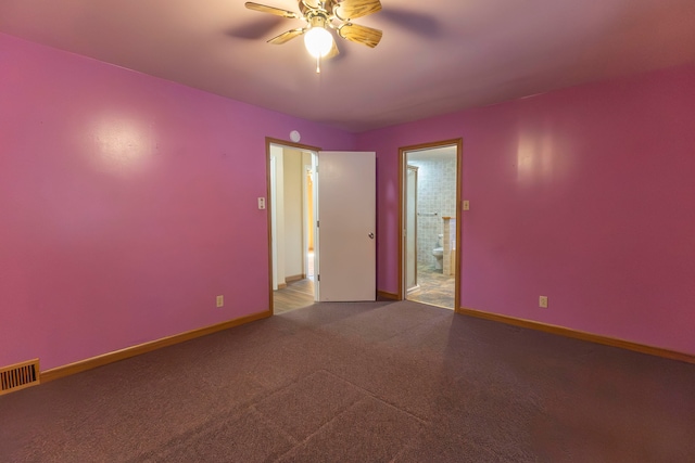 carpeted spare room featuring ceiling fan