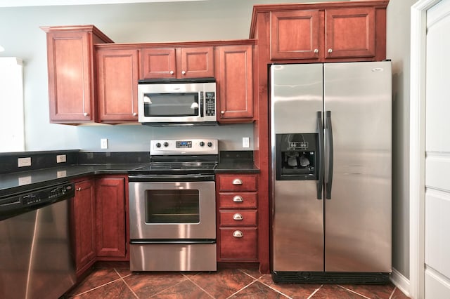 kitchen featuring dark stone countertops and appliances with stainless steel finishes