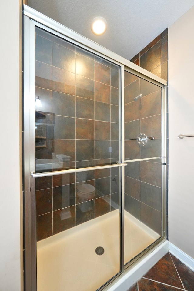 bathroom featuring tile patterned floors and an enclosed shower