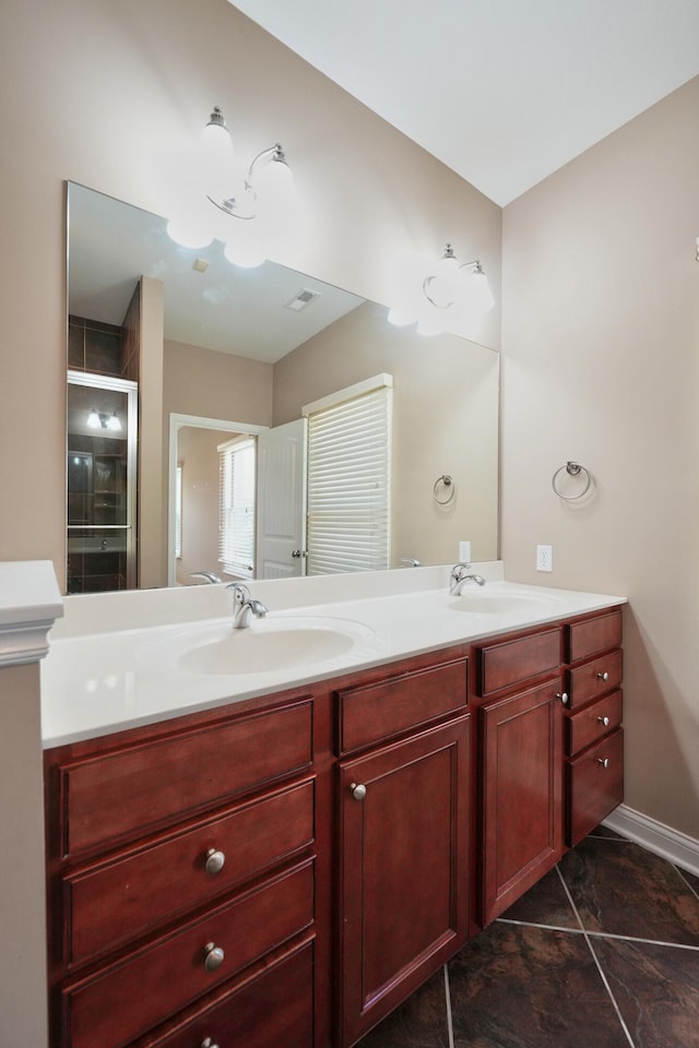 bathroom featuring tile patterned flooring, vanity, and an enclosed shower